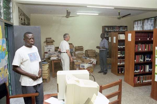 Books on left to be cataloged and shelved for the library