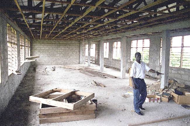 Dr. Obeng - showing third floor Bible College classroom construction progress - October 2000